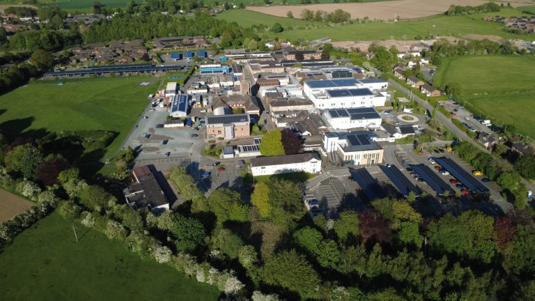 Aerial drone view of RJAH Hospital in Oswestry, Shropshire, showing solar carports and surrounding site once completed in 2026